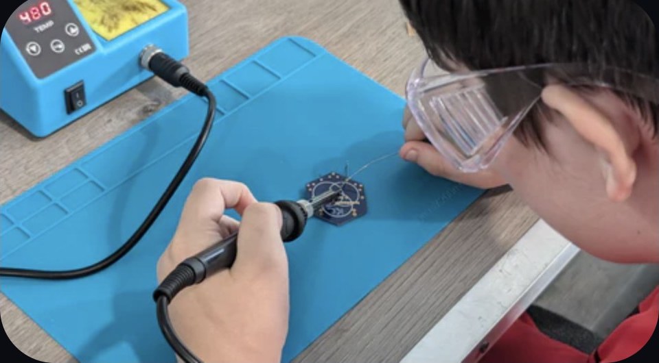 Camper soldering a flight board